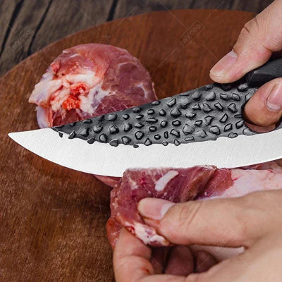feuille de boucher dans une main coupant de la viande en fine lamelle